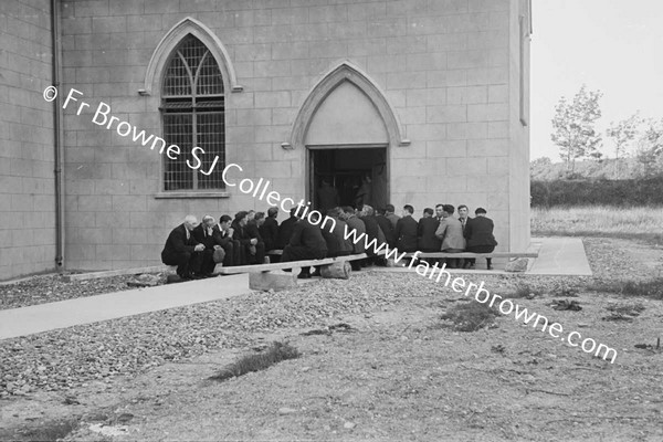 AFTER WOMENS CLOSING MEN KNEELING OUTSIDE CHURCH